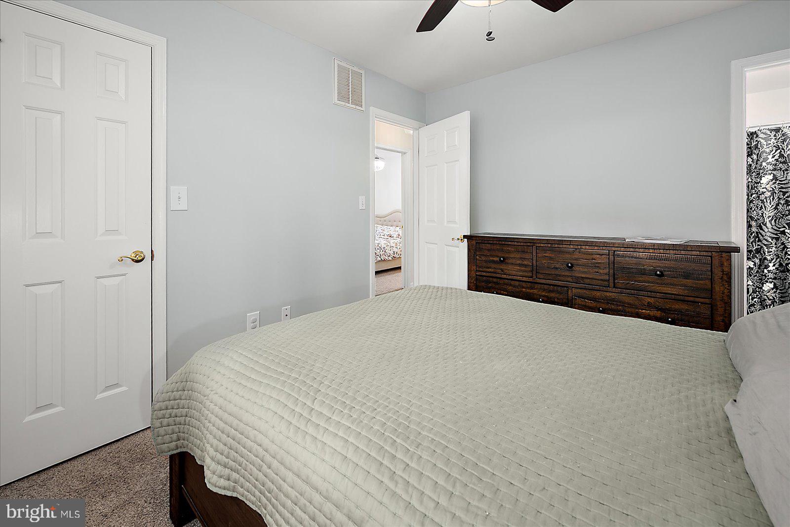 74 Robin Hood Trail Ocean Pines, MD 21811 - Photo 22 of 59 a bedroom with a bed and a dresser