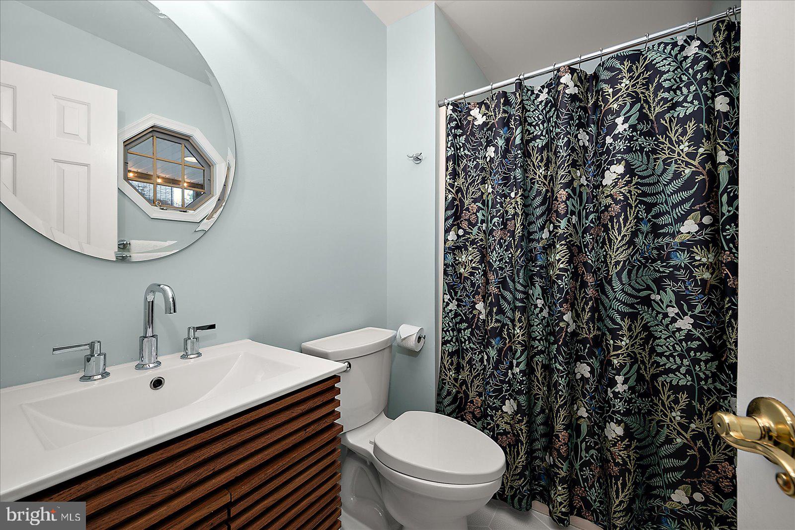 74 Robin Hood Trail Ocean Pines, MD 21811 - Photo 23 of 59 a bathroom with a sink a toilet and a mirror