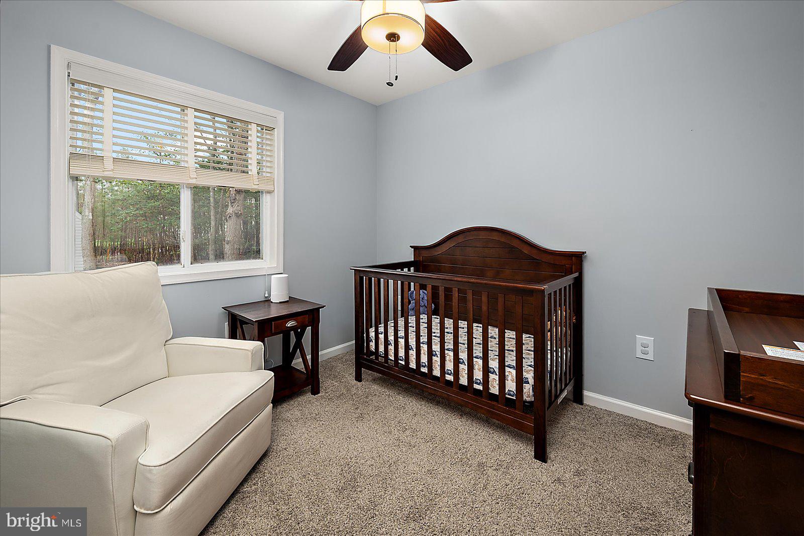 74 Robin Hood Trail Ocean Pines, MD 21811 - Photo 28 of 59 a living room with a baby crib furniture and a baby crib