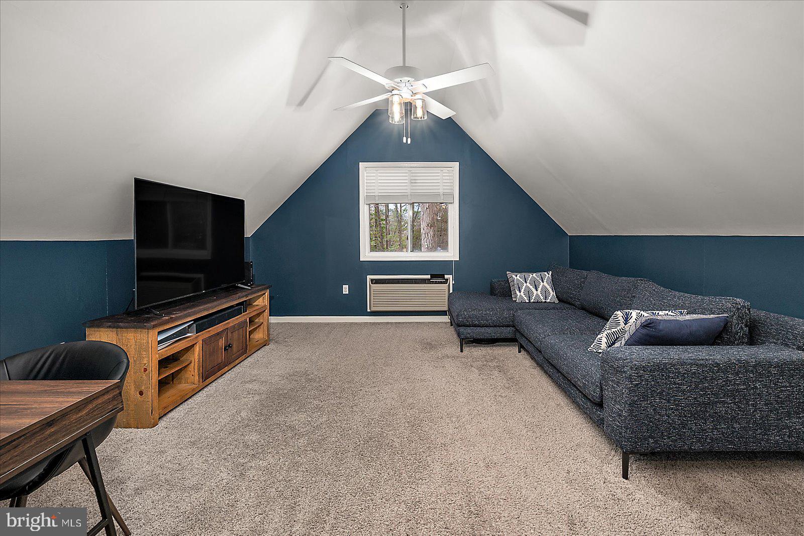 74 Robin Hood Trail Ocean Pines, MD 21811 - Photo 30 of 59 a living room with furniture and a flat screen tv