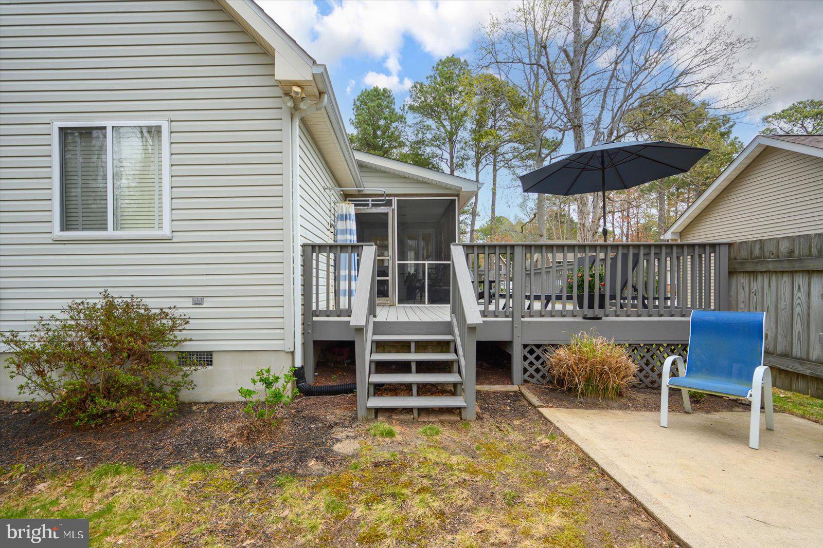 74 Robin Hood Trail Ocean Pines, MD 21811 - Photo 46 of 59 a backyard of a house with table and chairs
