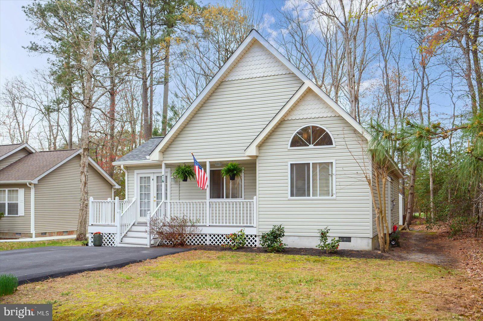 74 Robin Hood Trail Ocean Pines, MD 21811 - Photo 53 of 59 a view of a white house with a small yard and swimming pool