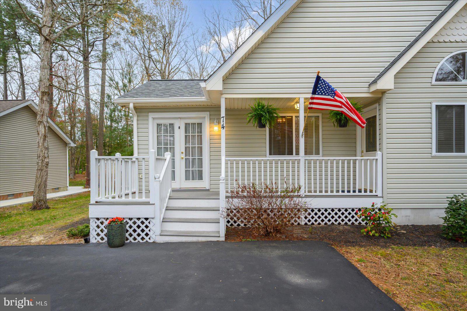 74 Robin Hood Trail Ocean Pines, MD 21811 - Photo 55 of 59 a view of a house with a small yard and wooden fence and a large tree