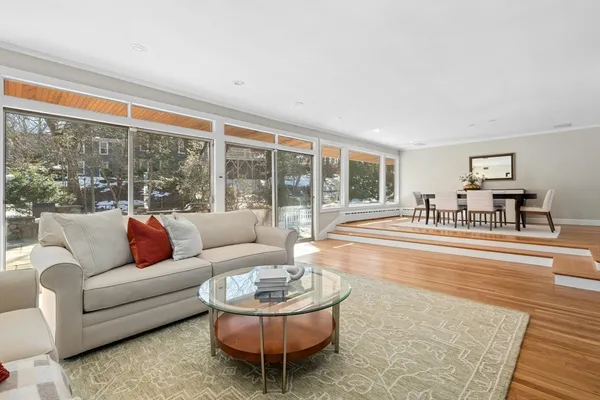 a living room with furniture and wooden floor