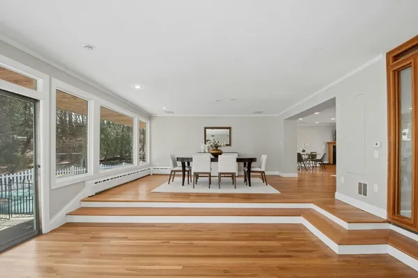 a living room with fireplace furniture and a wooden floor