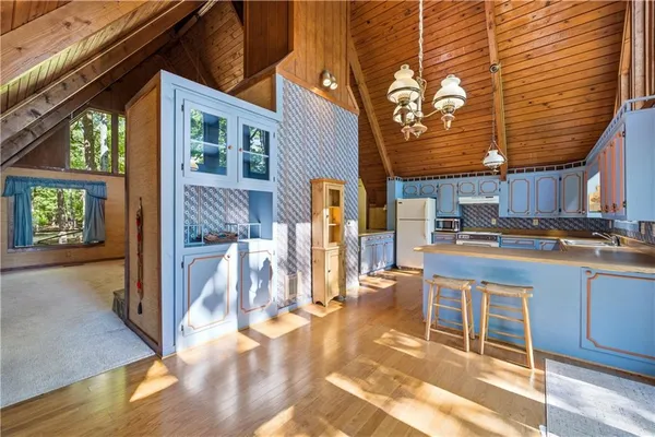 a kitchen with kitchen island granite countertop a stove a sink and dishwasher next to a window