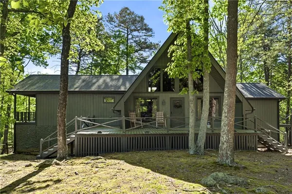 a view of a house with a tree beside it