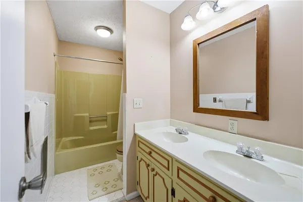 a bathroom with a tub and shower