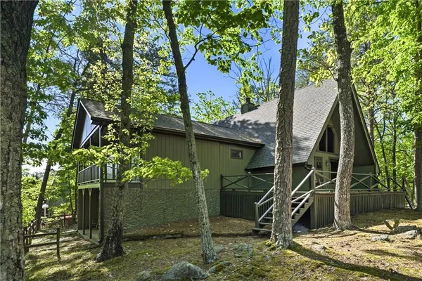 an aerial view of a house with a yard and lake view
