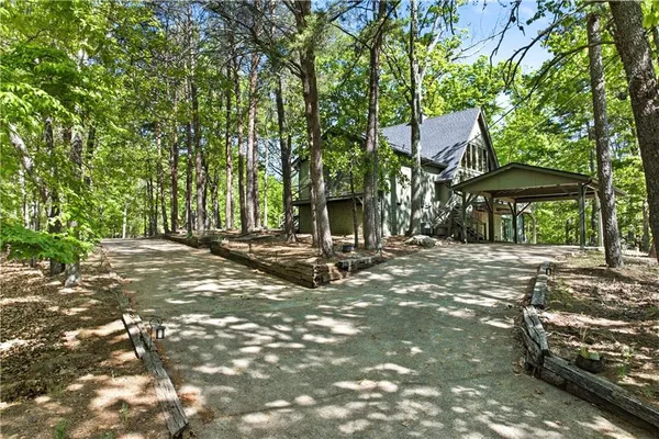 an aerial view of a house with a yard and large trees