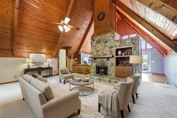 a living room with furniture a fireplace and a chandelier