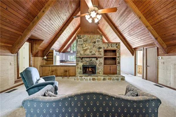 a living room with furniture a fireplace and a table