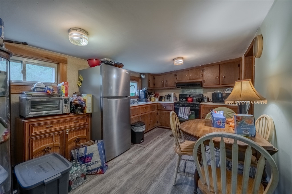 60 Valley Groton Ma Groton, MA 01450 - Photo 17 of 26 a kitchen with stainless steel appliances granite countertop a refrigerator a stove a sink dishwasher and a refrigerator with wooden floor
