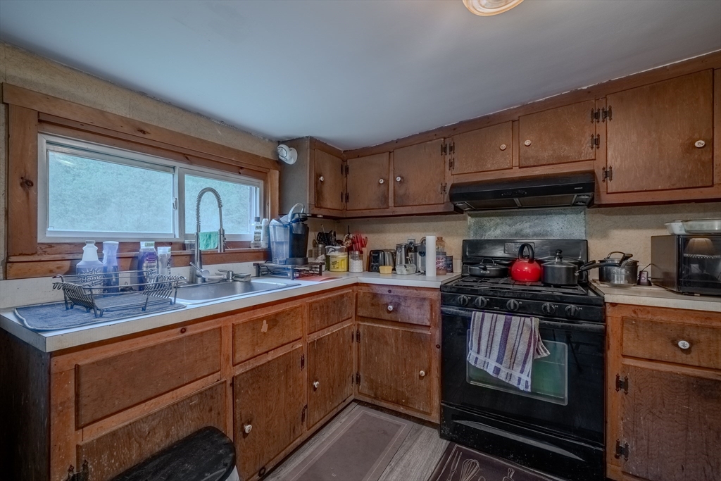 60 Valley Groton Ma Groton, MA 01450 - Photo 18 of 26 a kitchen with granite countertop a sink cabinets and stainless steel appliances