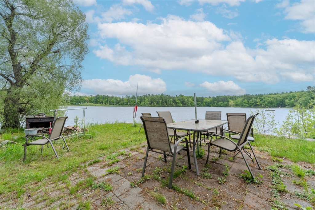 60 Valley Groton Ma Groton, MA 01450 - Photo 5 of 26 a view of a lake with table and chairs