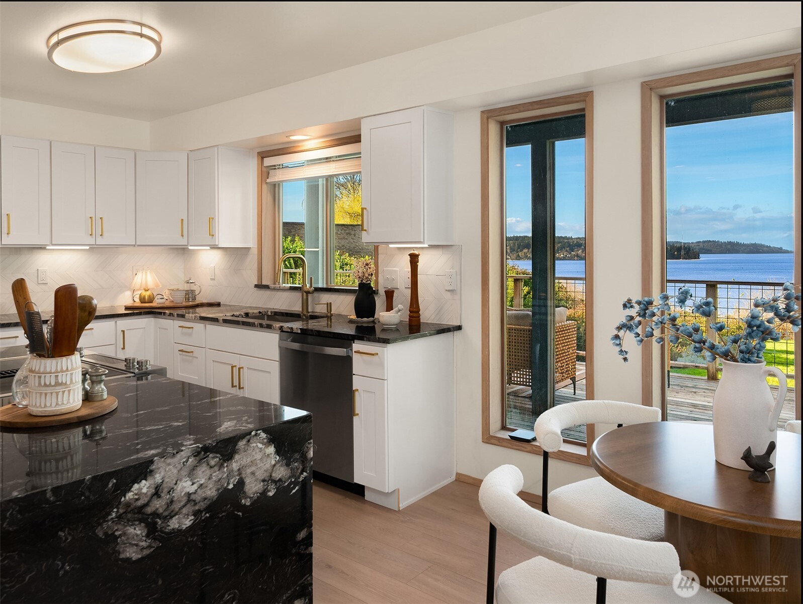 7010 Southwest Maury Park Road Vashon, WA 98070 - Photo 14 of 40 a kitchen with a table chairs stove and cabinets