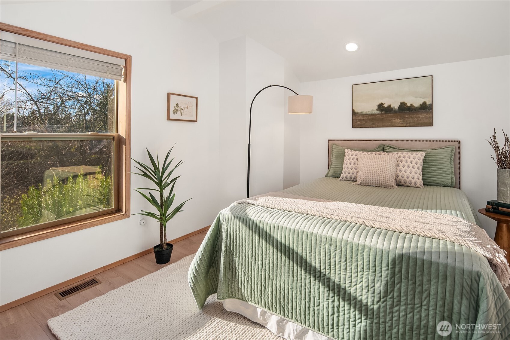 7010 Southwest Maury Park Road Vashon, WA 98070 - Photo 22 of 40 a bedroom with a large bed and a painting on the wall