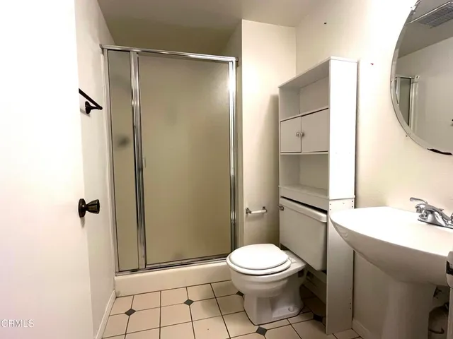 a bathroom with a toilet a sink and shower