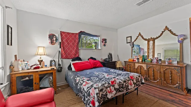 a bedroom with bed and a window