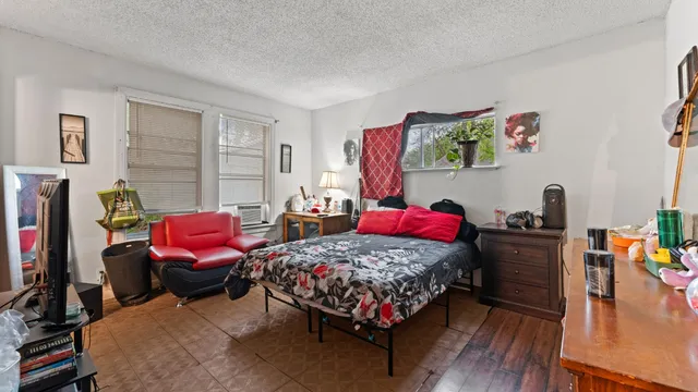 a bedroom with furniture a bed and a flat screen tv