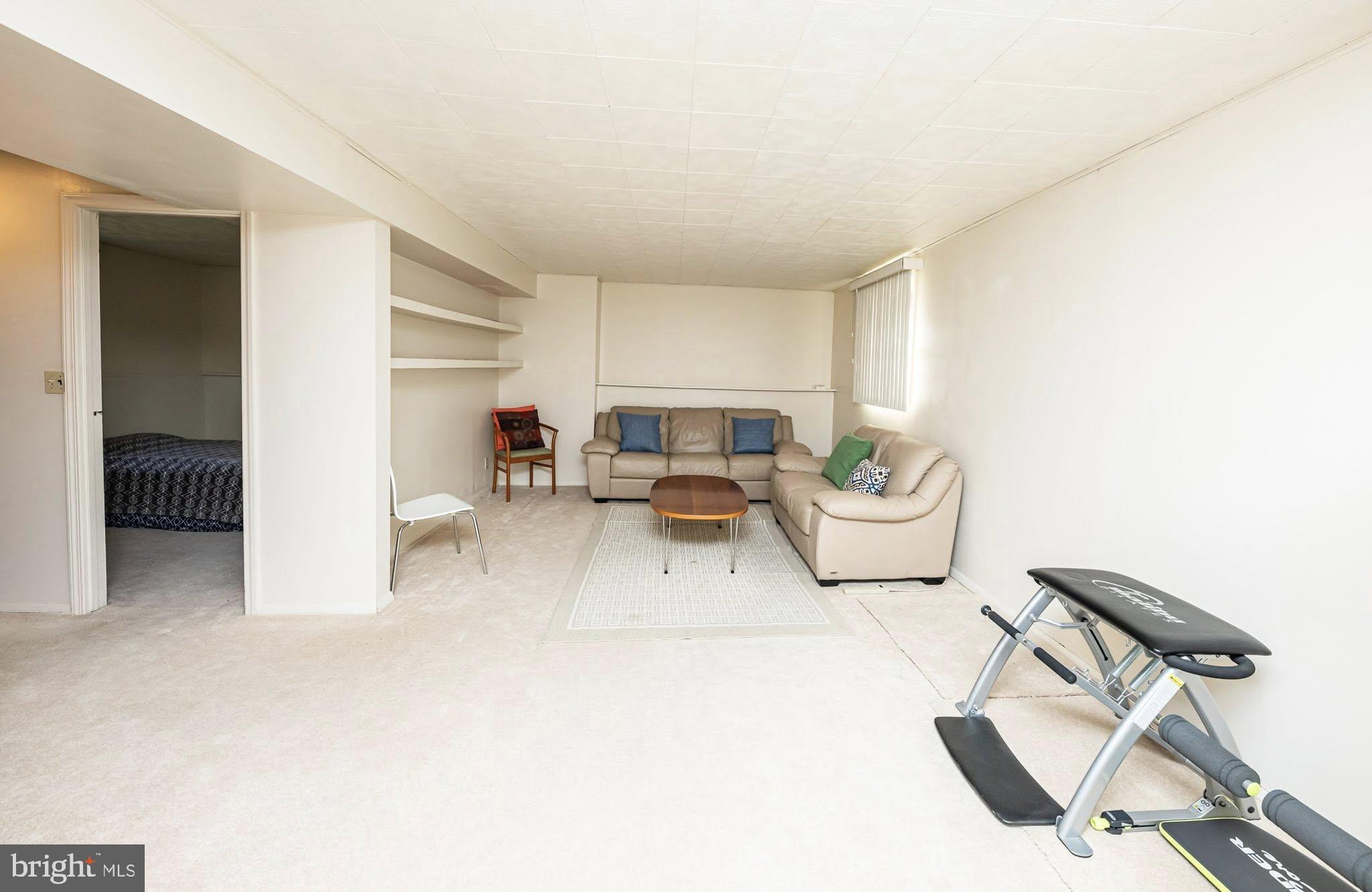 1803 East Beech Road Sterling, VA 20164 - Photo 14 of 38 a living room with furniture a flat screen tv and a window