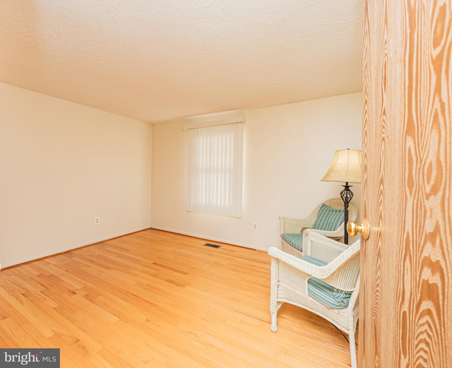 1803 East Beech Road Sterling, VA 20164 - Photo 23 of 38 a bedroom with a bed and a table in it