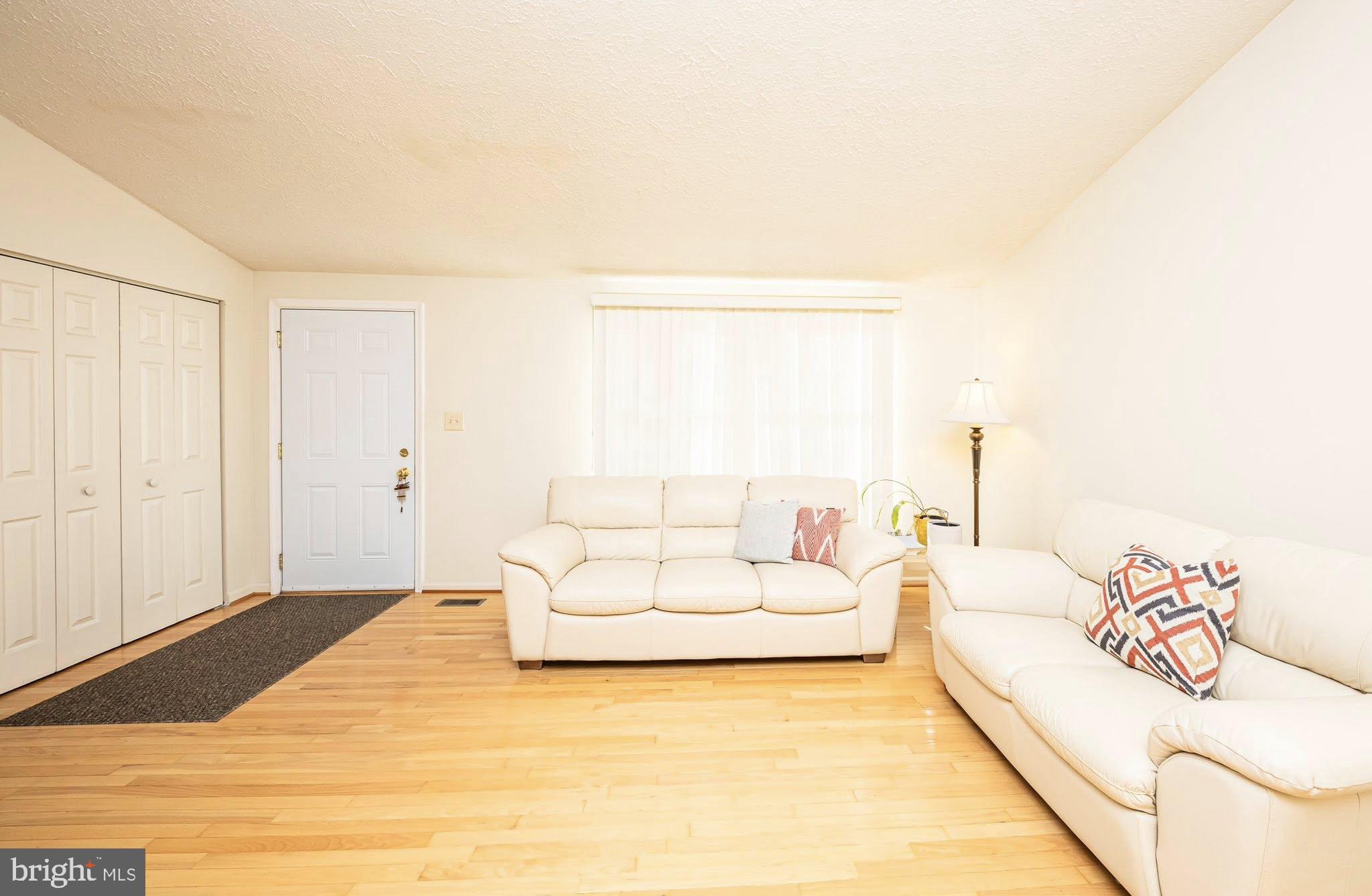 1803 East Beech Road Sterling, VA 20164 - Photo 6 of 38 a living room with furniture and a white bed