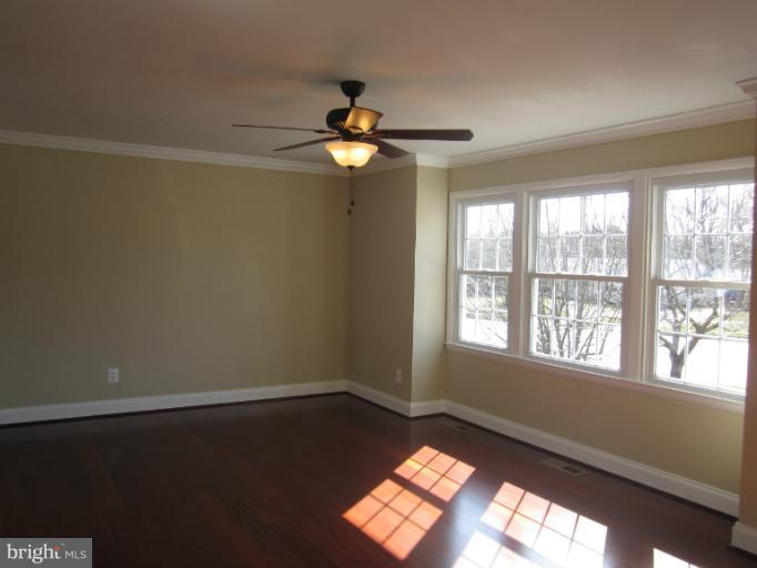 2107 Rolling Rd. Windsor Mill, MD 21244 - Photo 13 of 29 a view of empty room with wooden floor and fan
