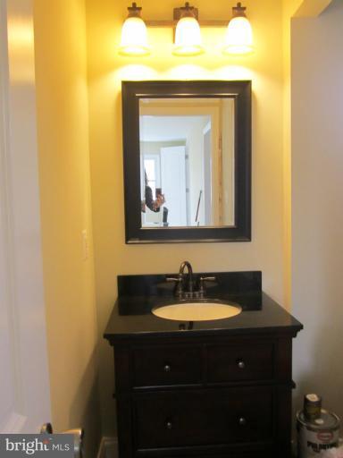 2107 Rolling Rd. Windsor Mill, MD 21244 - Photo 3 of 29 a bathroom with a sink and a mirror