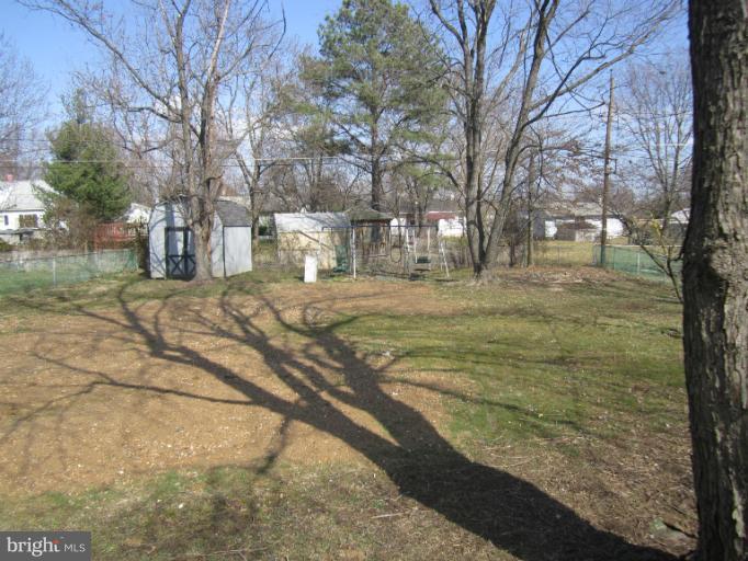 2107 Rolling Rd. Windsor Mill, MD 21244 - Photo 23 of 29 a view of a yard with plants and trees