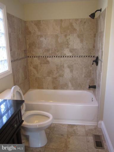 2107 Rolling Rd. Windsor Mill, MD 21244 - Photo 24 of 29 a bathroom with a sink a toilet and bathtub