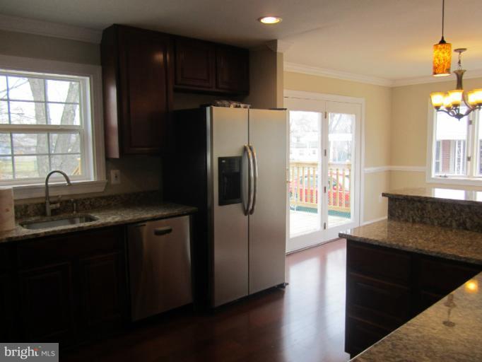 2107 Rolling Rd. Windsor Mill, MD 21244 - Photo 27 of 29 a kitchen with stainless steel appliances granite countertop a refrigerator and a sink