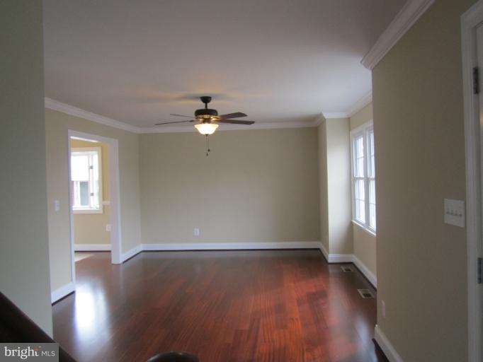 2107 Rolling Rd. Windsor Mill, MD 21244 - Photo 4 of 29 wooden floor in an empty room with a window