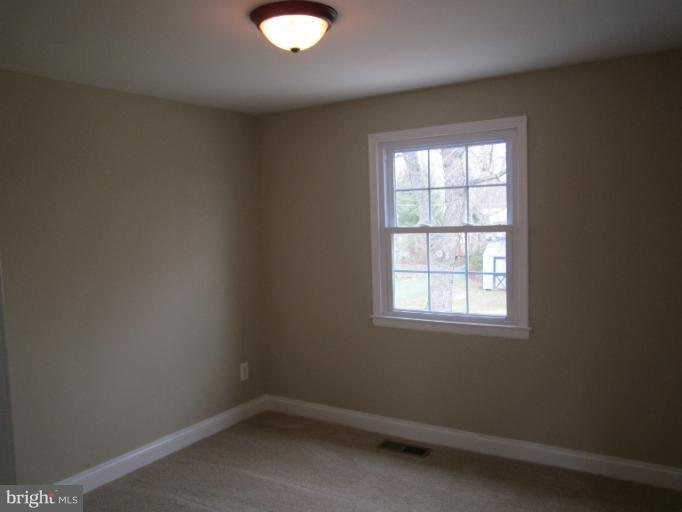 2107 Rolling Rd. Windsor Mill, MD 21244 - Photo 7 of 29 an empty room with a window
