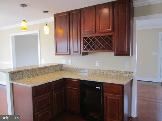 2107 Rolling Rd. Windsor Mill, MD 21244 - Photo 10 of 29 a kitchen with wooden cabinets and a sink
