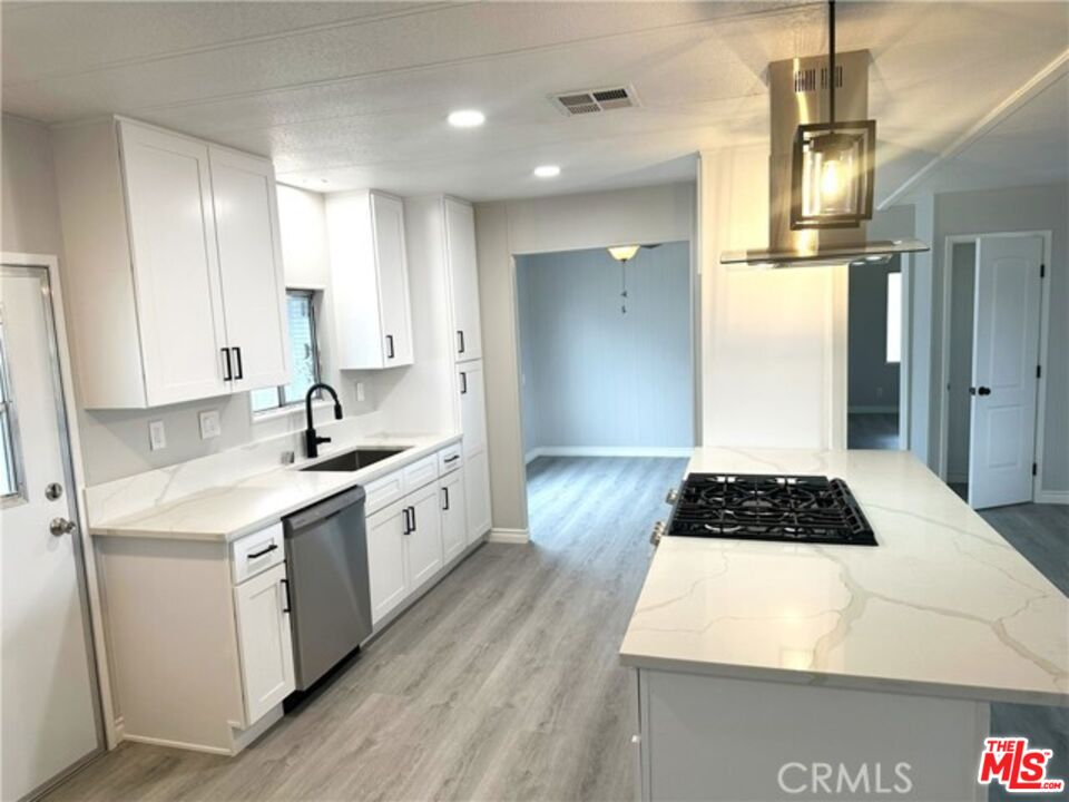 9391 California Avenue, Unit 89 Riverside, CA 92503 - Photo 3 of 16 a kitchen with a sink stove and refrigerator