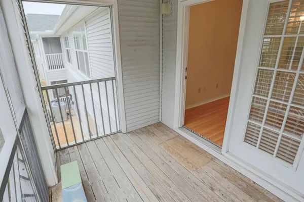 a view of wooden floor and brick wall