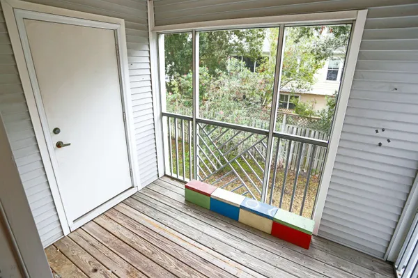 a view of a balcony with wooden floor