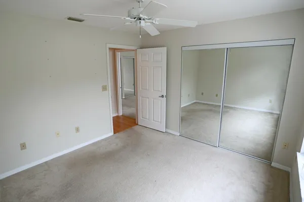 an empty room with fan and entrance