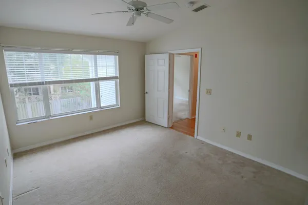 an empty room with a empty space and windows