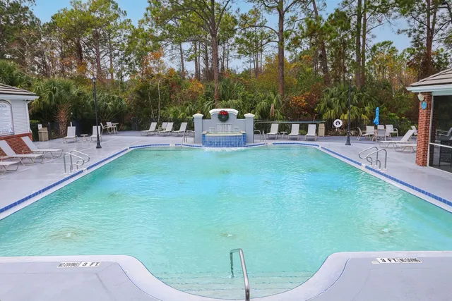 a view of a house with swimming pool and sitting area