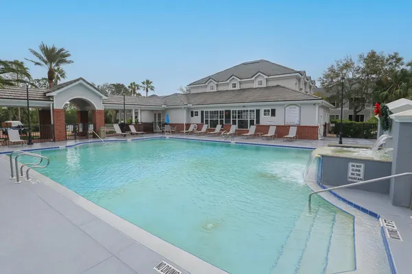 a kitchen with a table chairs and wooden floor