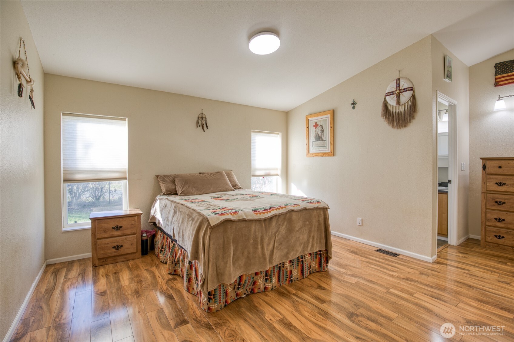 4687 Wishkah Road Aberdeen, WA 98520 - Photo 11 of 29 a bedroom with a bed and wooden floor