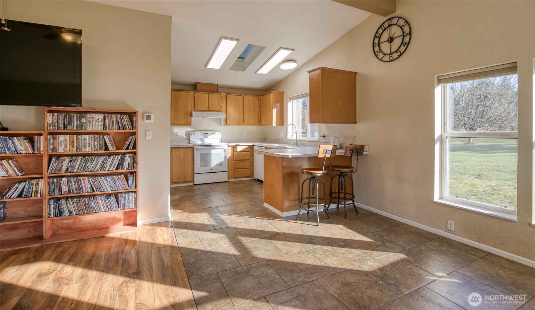 4687 Wishkah Road Aberdeen, WA 98520 - Photo 6 of 29 a view of a workspace with furniture and a flat screen tv