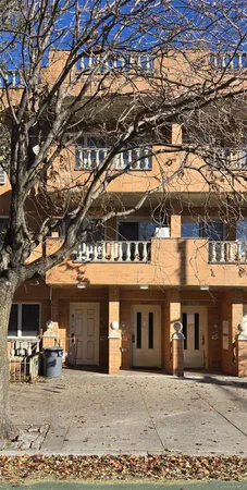 a front view of a building with parking area