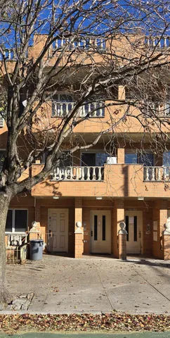 a front view of a building with parking area