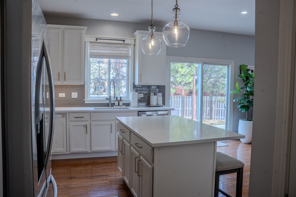 250 Tiger Street Bolingbrook, IL 60490 - Photo 11 of 36 a kitchen with kitchen island granite countertop a sink stove and refrigerator