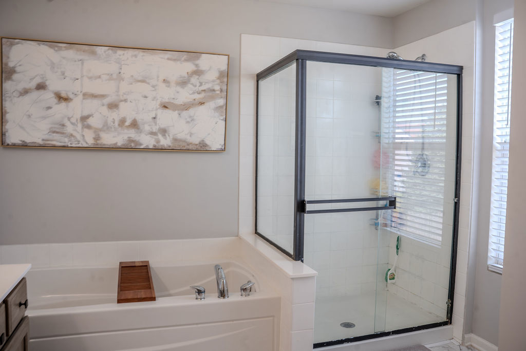 250 Tiger Street Bolingbrook, IL 60490 - Photo 25 of 36 a bathroom with a bathtub and a shower