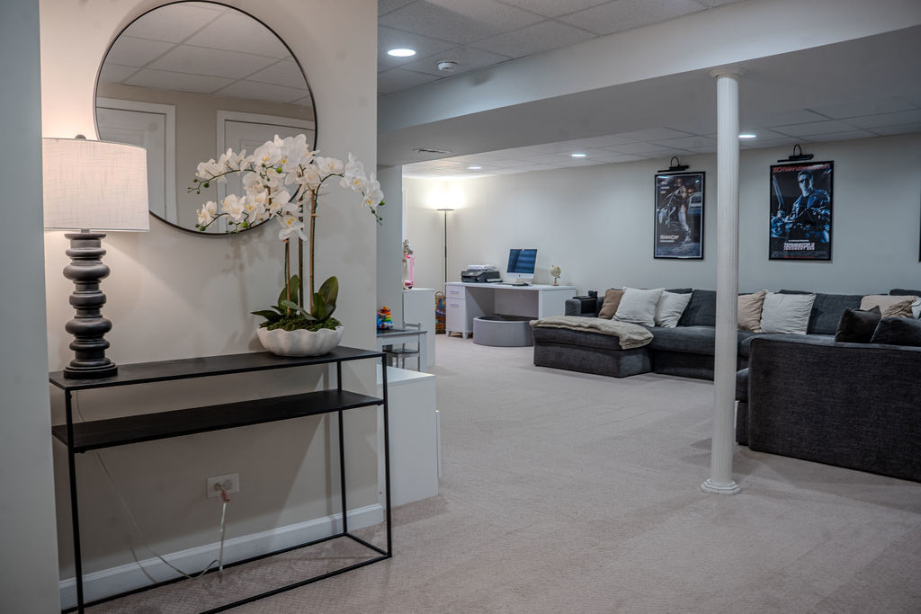 250 Tiger Street Bolingbrook, IL 60490 - Photo 28 of 36 a living room with furniture a chandelier and a mirror