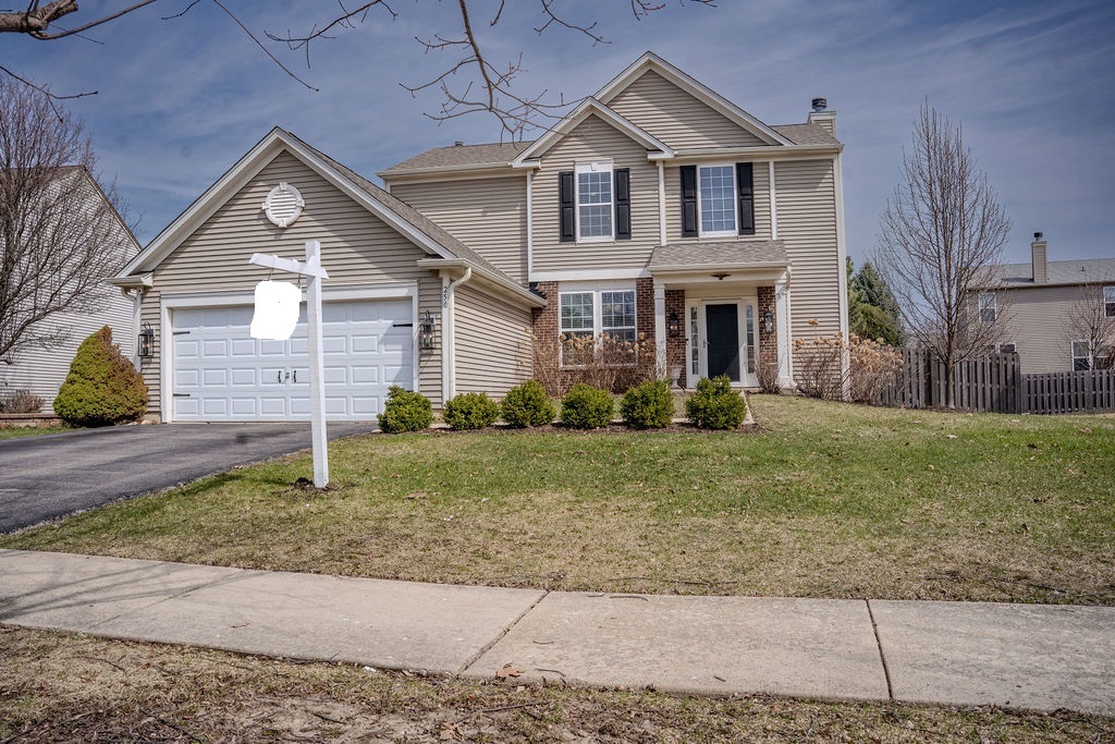 250 Tiger Street Bolingbrook, IL 60490 - Photo 3 of 36 a front view of a house with a yard